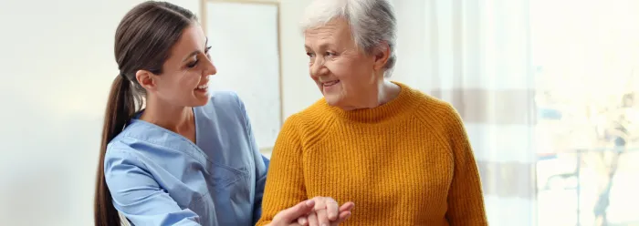 Care worker helping elderly