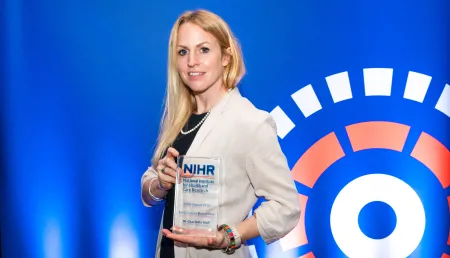Photo of Dr Charlotte Hall with her award